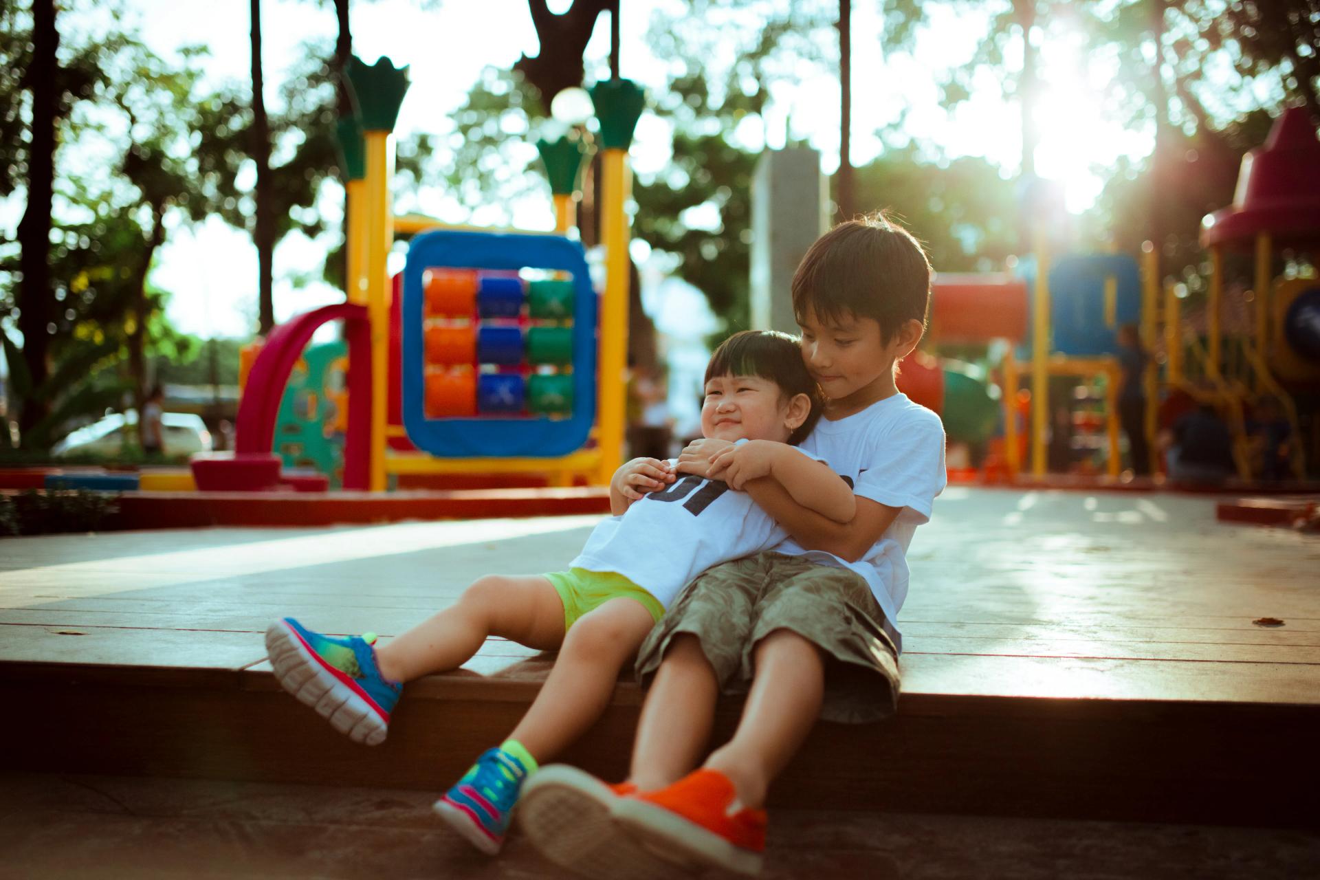 Two young kids playing in a play park