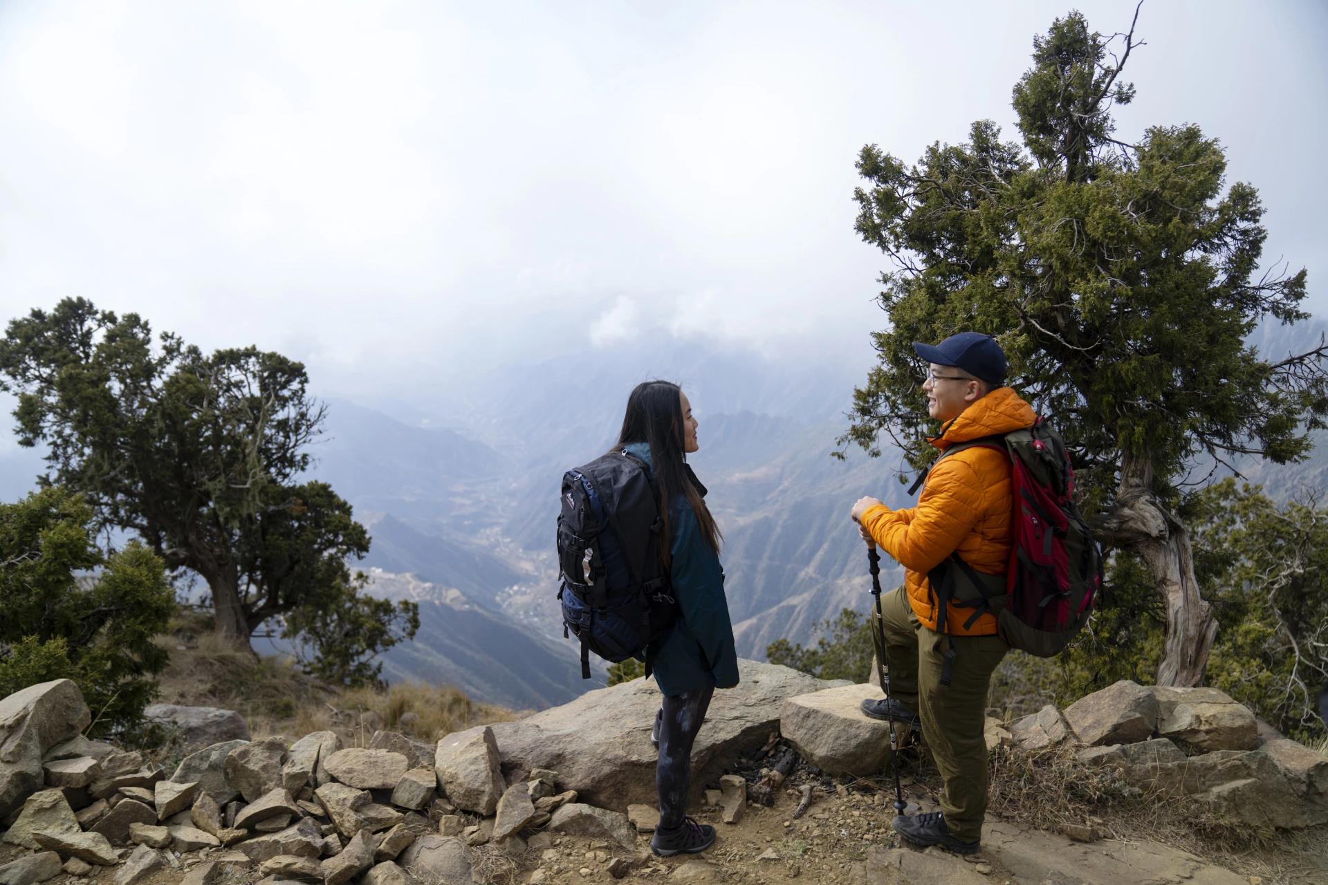 Two tourists admiring mountain views in Aseer